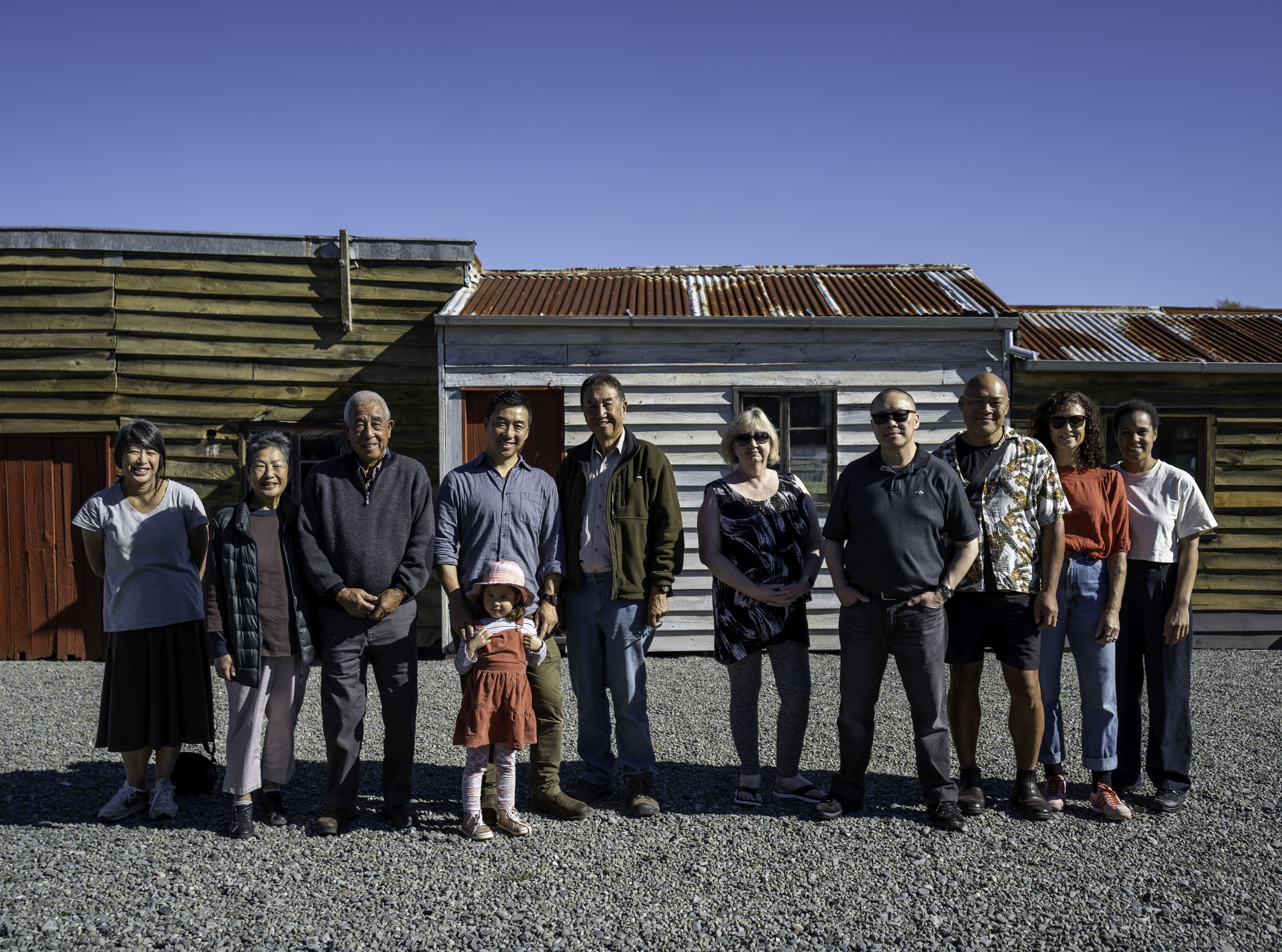 Group of people standing in front of old wooden buildings