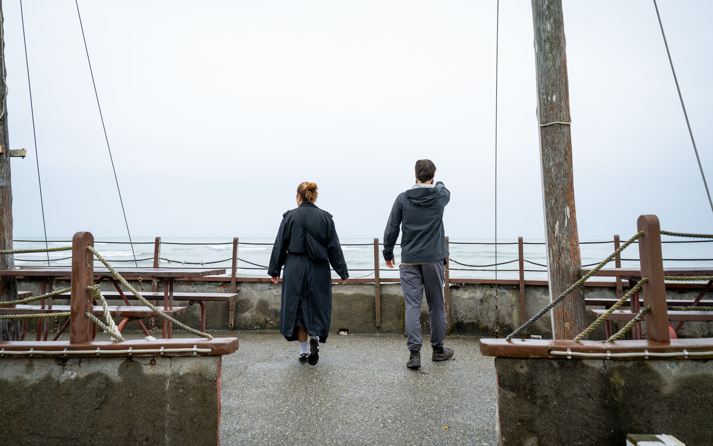 man and women on recreated ship at sea edge