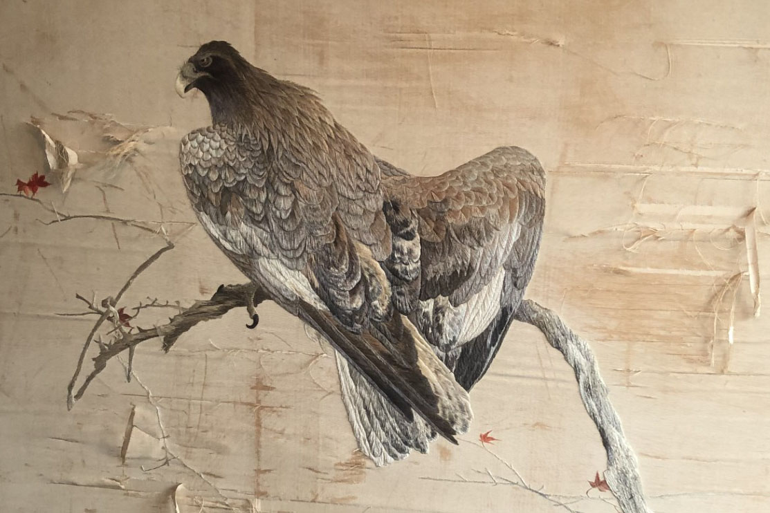 eagle embroidery before its restoration with tattered pieces
