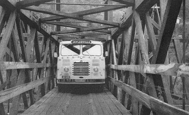 black and white photo of 1960s bus on timber bridge