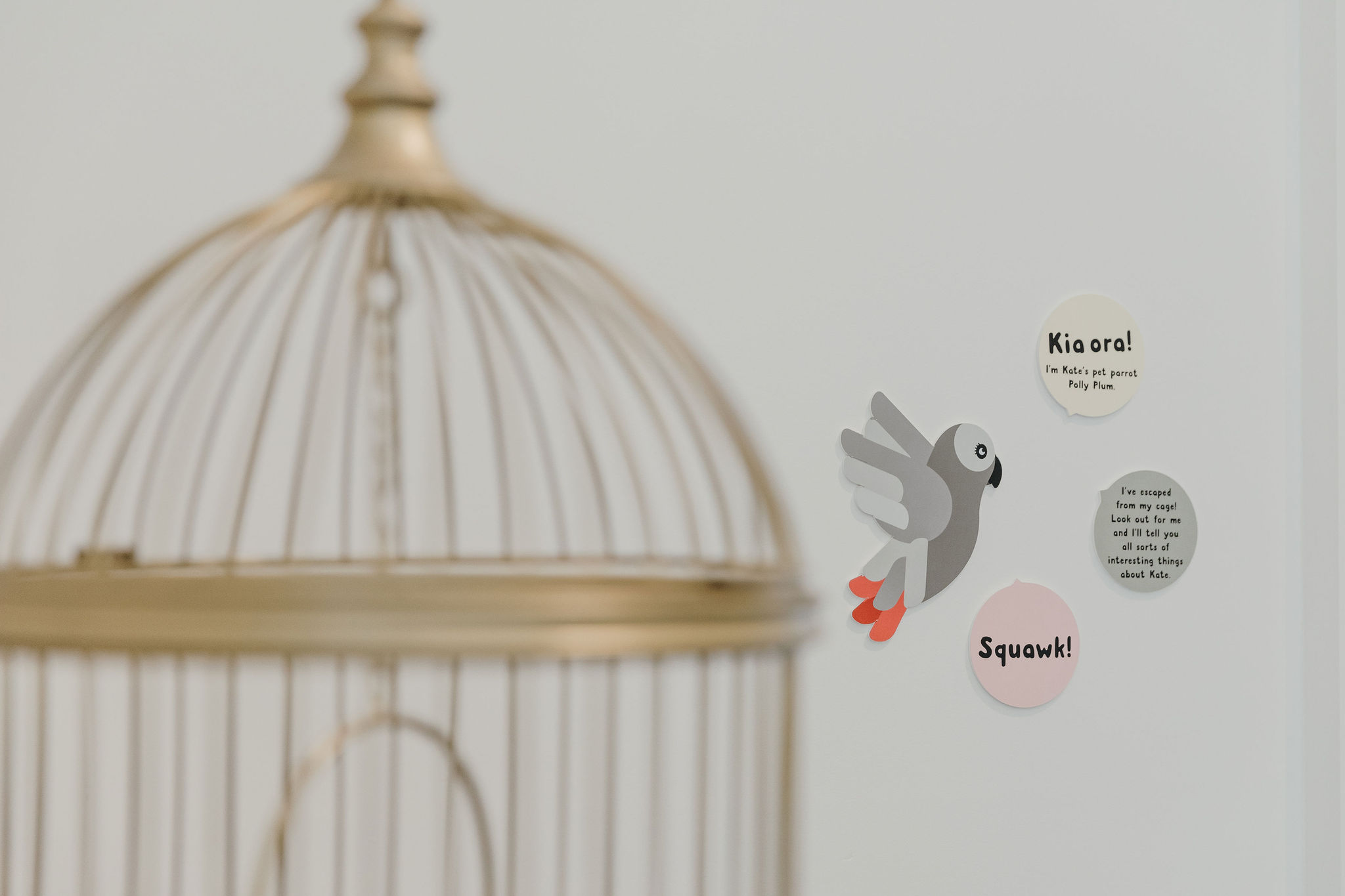 parrot cage and parrot decal on wall